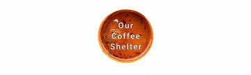 A circular brown coffee cup graphic with the text 'Our Coffee Shelter' in white, centered on a plain white background.
